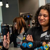 Event guest listening while in conversation with other attendee
